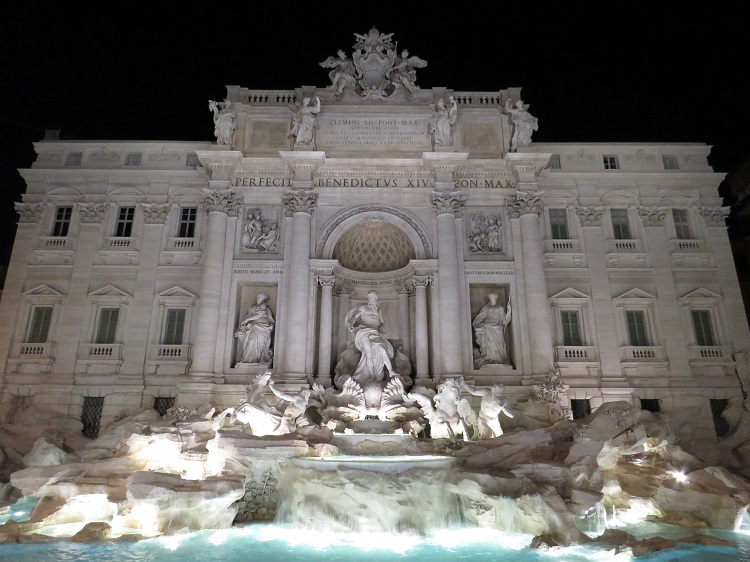 Trevi fountain at night, with pristine marble statues